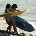 Surfers walking into the water with their boards
